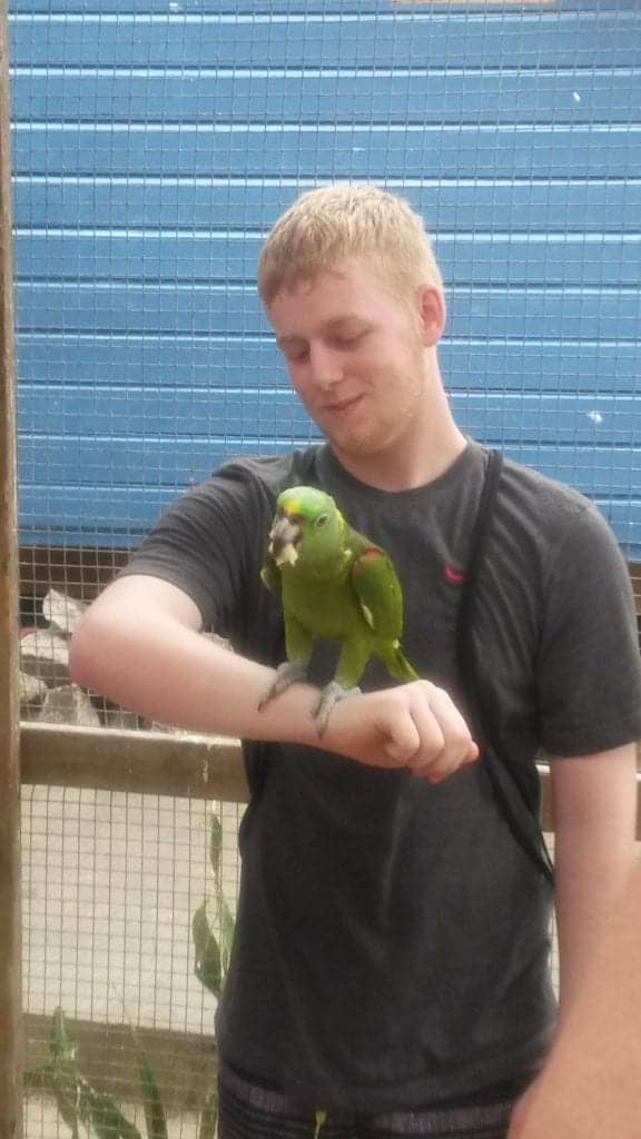 Sloths and Monkeys: The Best Mahogony Bay Excursion 17 Holding a parrot Roatan