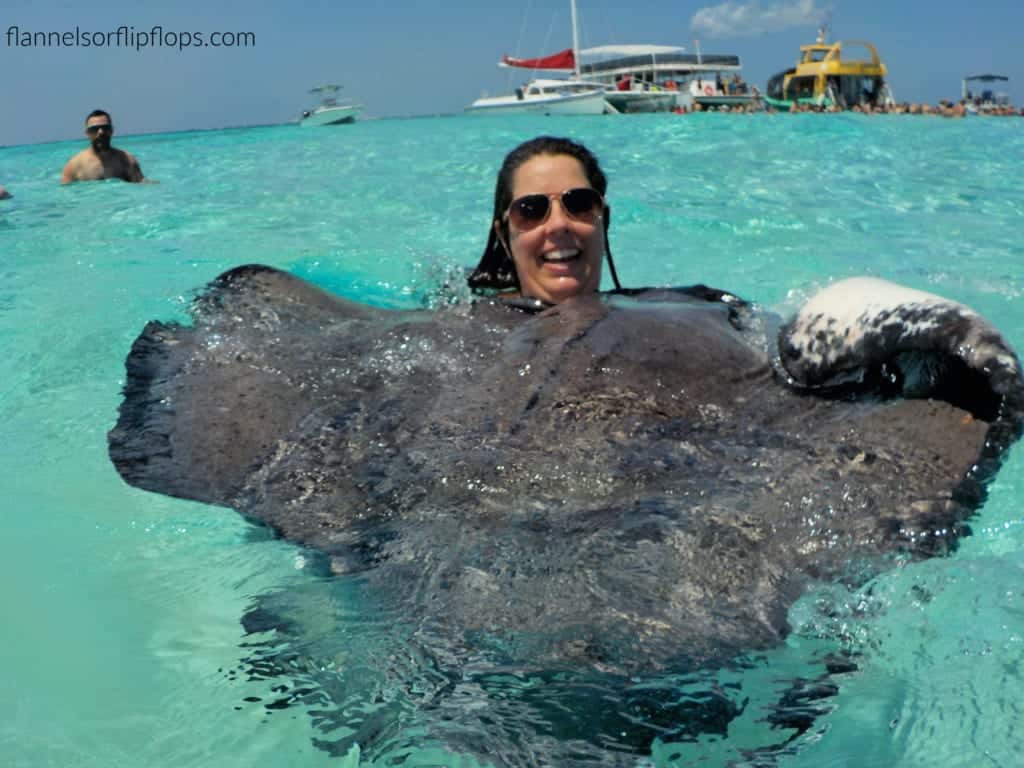 Me and my husband swimming with stingrays in crystal clear waters in a Stingray City Tour