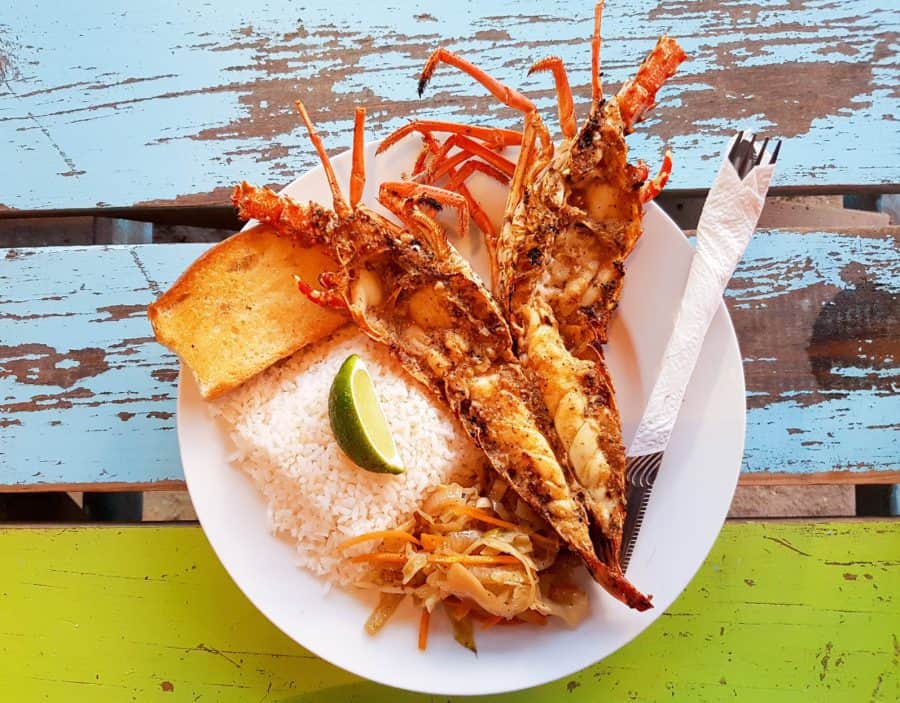 Eating lobster wit lemon and rice in Belize.
