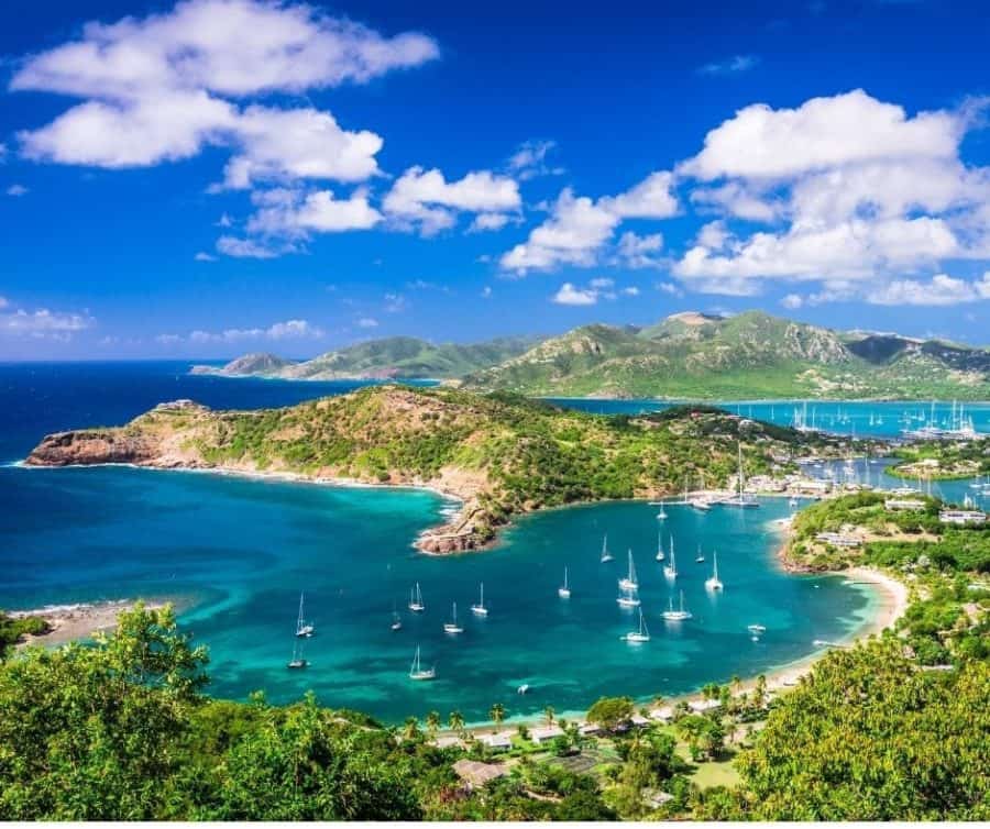 A stunning aerial view of the lush, tropical Caribbean islands surrounded by crystal clear blue waters and white sandy beaches.
