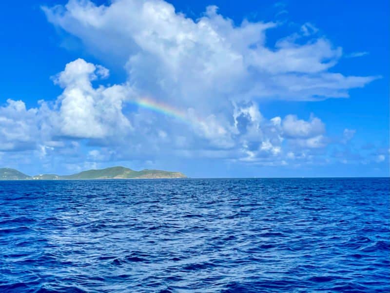Rainbow over Tortola wit clear blue waters.
