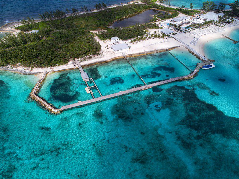 10 Best Beaches In Nassau For Cruisers 12 An aerial view of Balmoral Island, displaying its stunning beaches, clear blue waters, and lush island greenery.