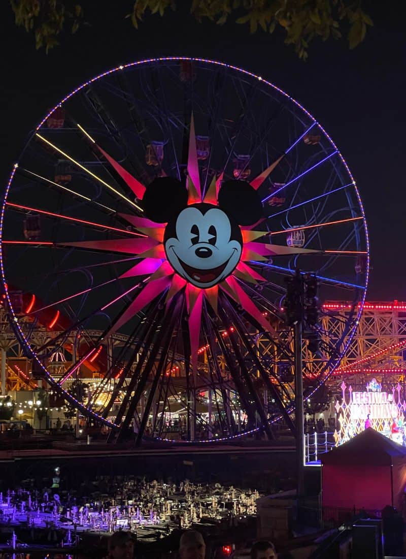 Disneys California Adventure Park Ferris Wheel with Mickey on it at night.