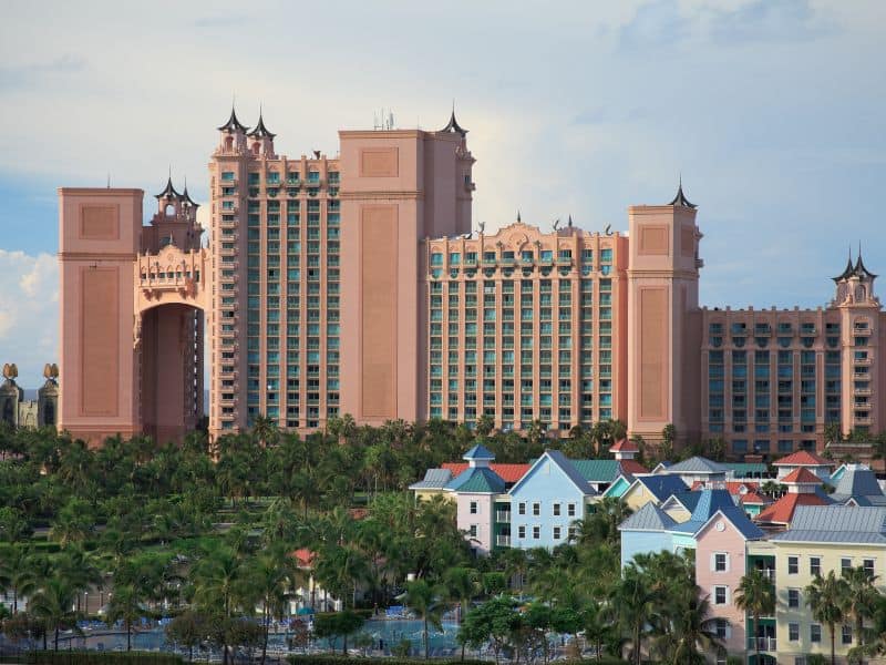 10 Unmissable Experiences in Nassau That Will Make Your Bahamas Trip Unforgettable! 3 Tall buildings at the Atlantis Resort. These structures are characterized by their modern, sleek design, often with reflective glass facades that shimmer under the sunlight.
