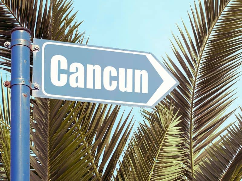 Cancun Sign surrounded by palm trees