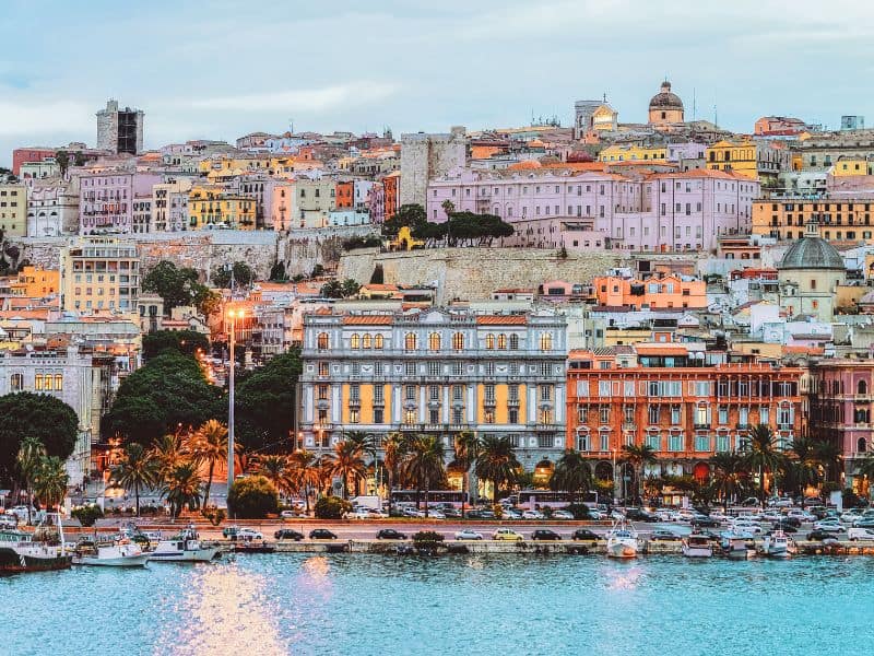 COLORED BUILDINGS AND THE OCEAN IN SARDINIA