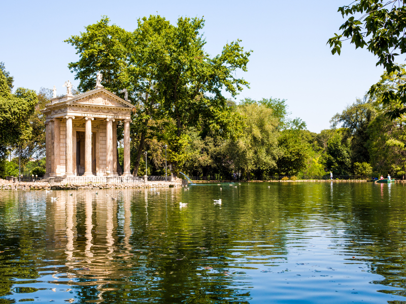 30 Famous Rome Italy Landmarks That You Must See 17 An expansive and picturesque public park, Villa Borghese in Rome, Italy. Couples on the boat adorn the tranquil lake's landscape, offering a serene retreat within the bustling city, with the gulls swimming around the lake.