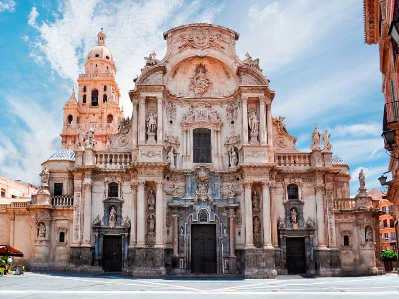 The magnificent Cathedral Church of Saint Mary in Murcia, Spain, with its intricate Gothic architecture and towering spires, evoking a sense of divine grandeur.