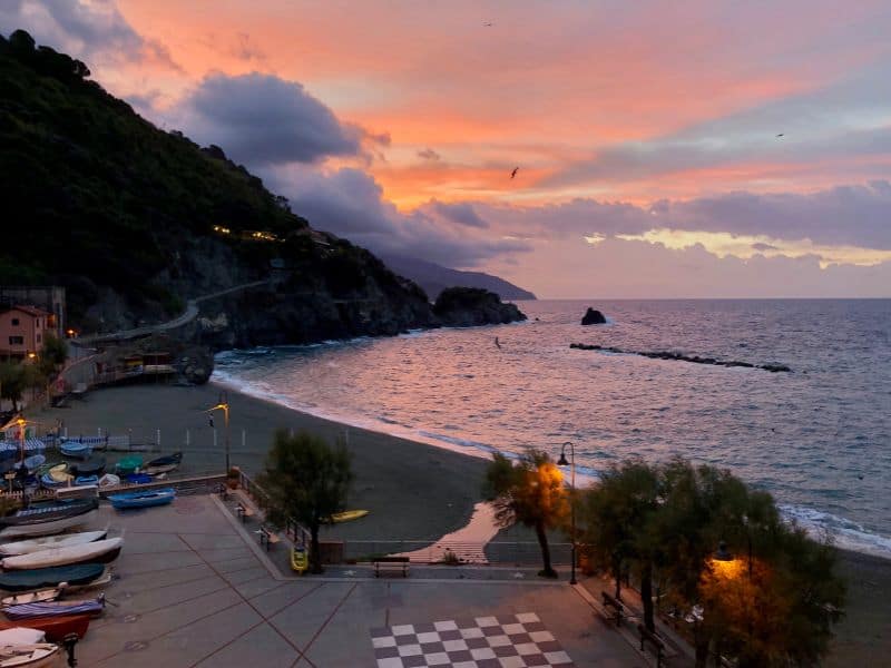 10 Best Livorno Shore Excursions 5 The picturesque coastal view of Cinque Terre, Italy, basks in the warm hues of a breathtaking sunset.