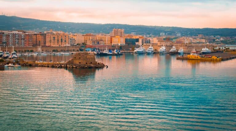 Civitavecchia Cruise Port at sunset, with a serene view of the harbor bathed in the warm, golden light of the setting sun.