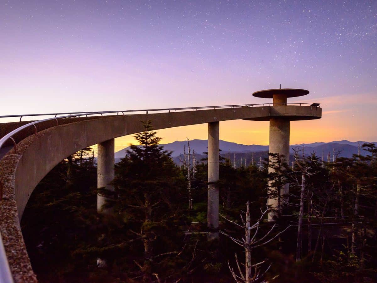 Best Places to Explore in the Great Smoky Mountains 5 Clingmans Dome Road bathed in the soft glow of the afternoon light, casting long shadows and illuminating the surrounding landscape with a warm, golden hue.