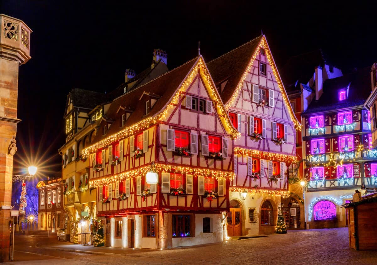 Traditional old half-timbered houses in the historic city of Colmar. Decorated and lighted during the Christmas season. Alsace. France.