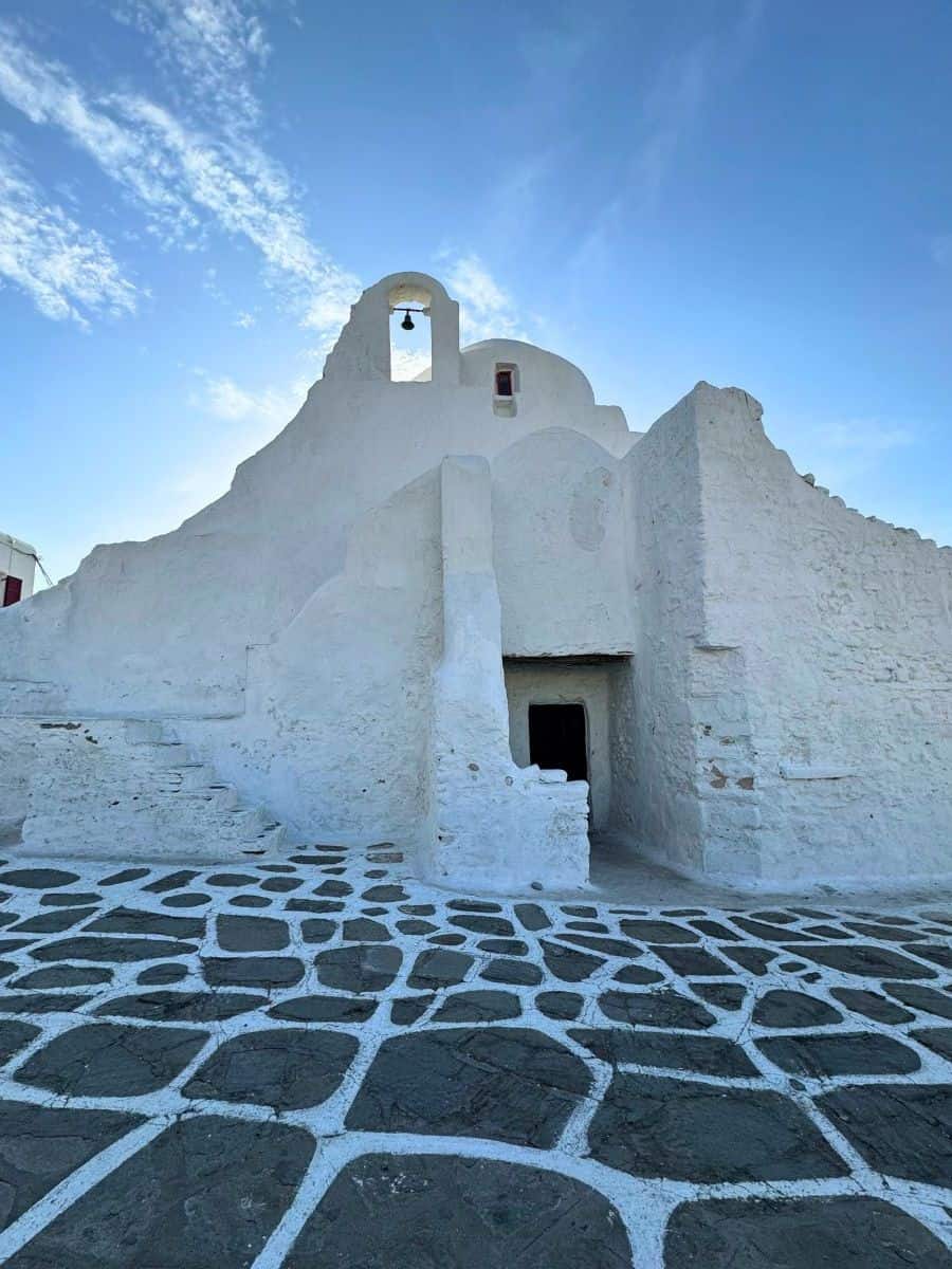 The Greek Orthodox Church of Panagia Paraportiani in Mykonos, Greece, a unique, whitewashed church known for its distinctive, asymmetrical architecture.