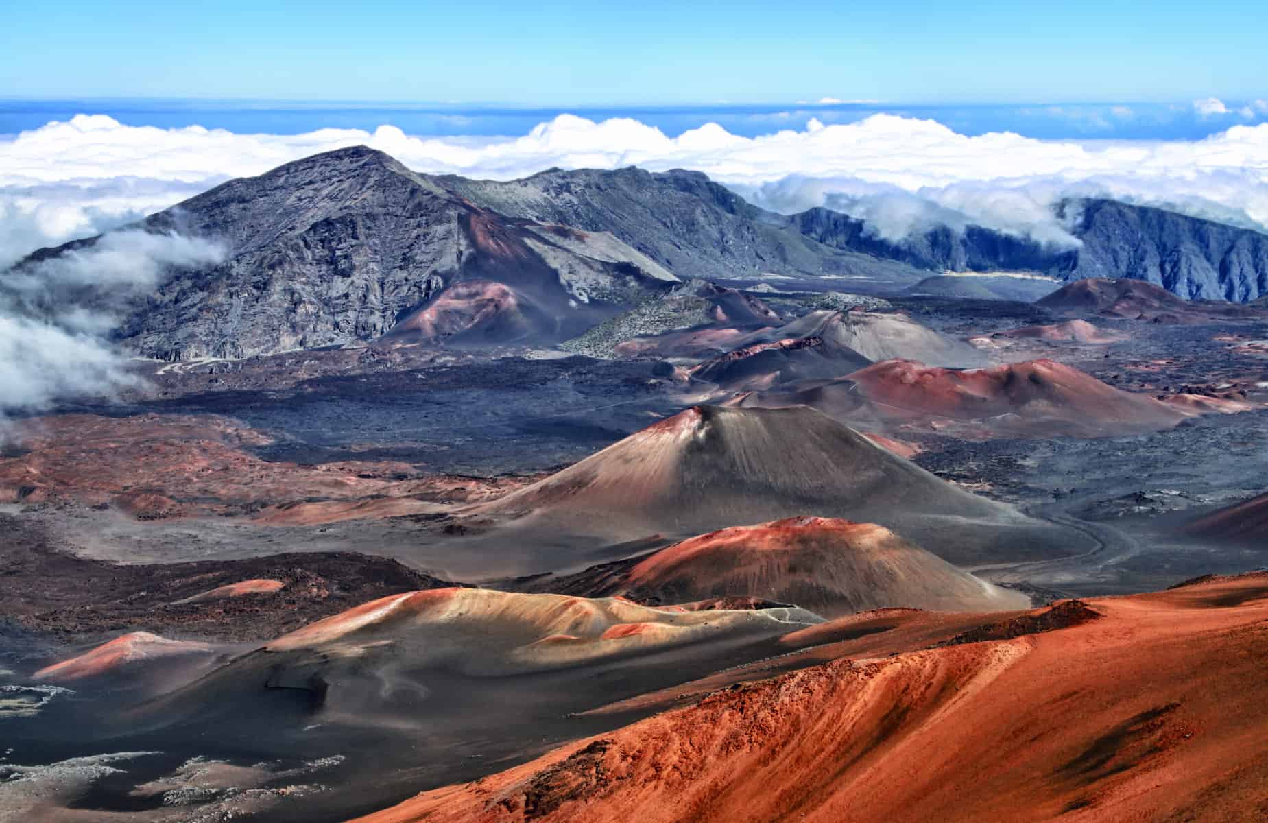 10 Breathtaking National Parks That Stay Warm During The Winter 3 "View of the vast, colorful Haleakalā crater with its unique cinder cones, under a clear blue sky in Haleakalā National Park, Maui.