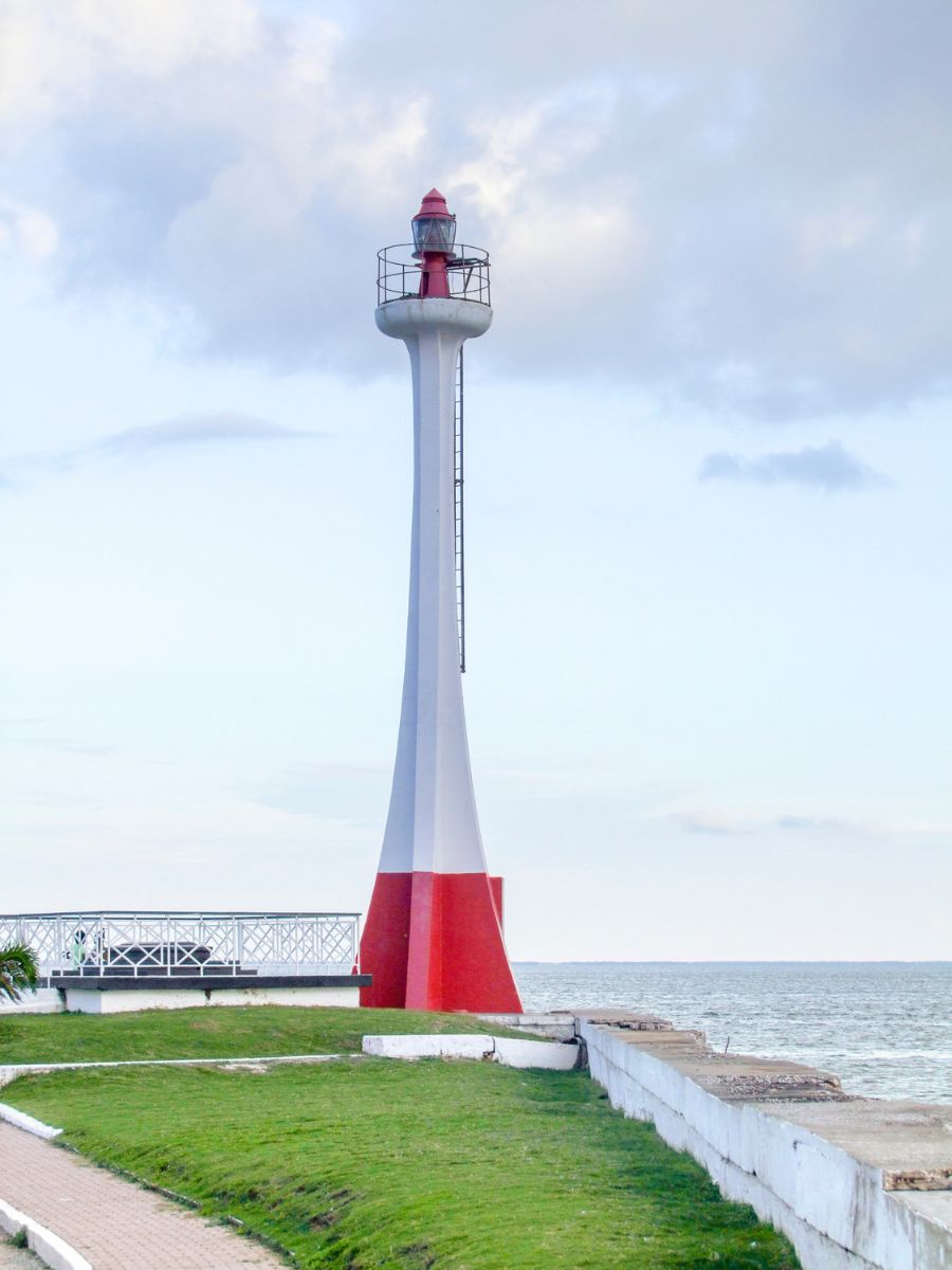 Baron Bliss Lighthouse in Belize, captured during daylight with its distinctive white and red structure against a clear blue sky.