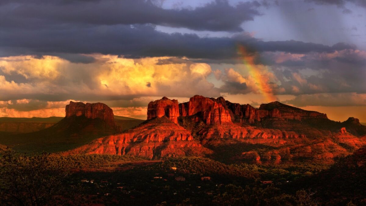 Desert scenery with storm and rainbow background