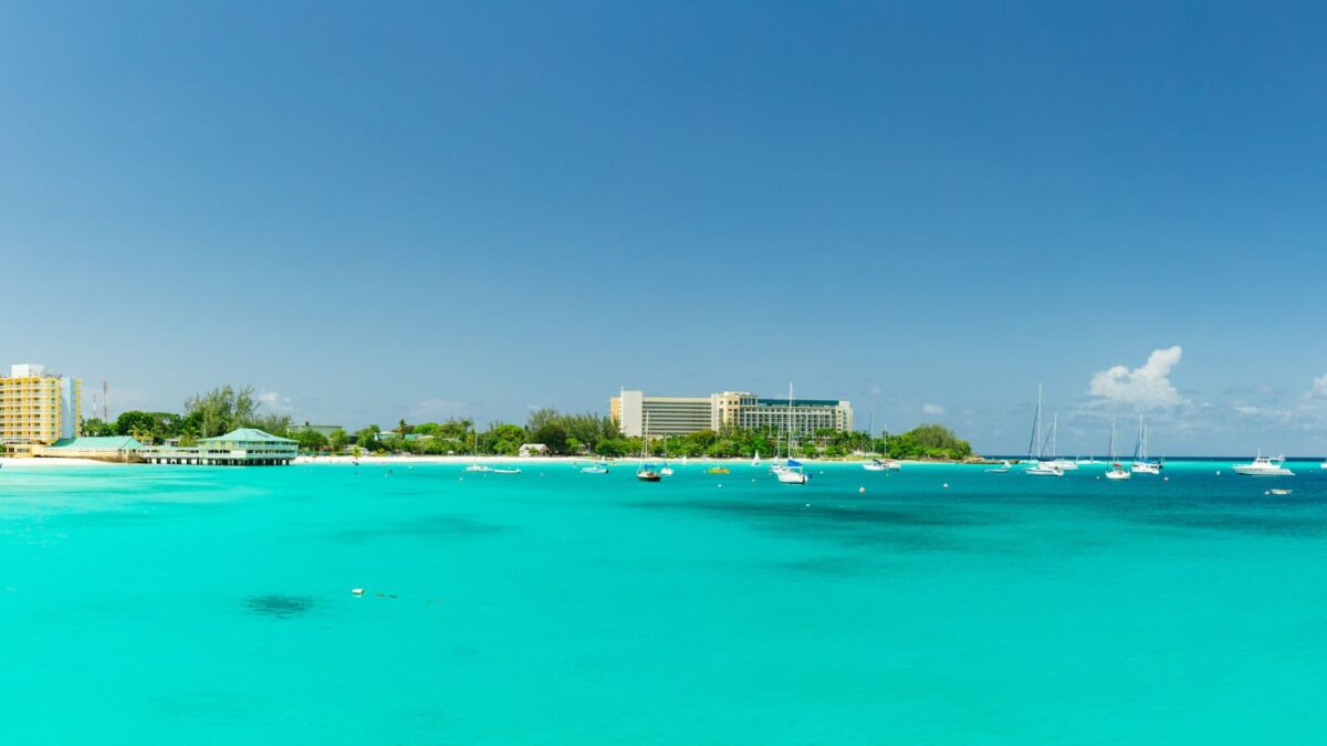 The Best Barbados Beaches Near Cruise Port To Explore 2 View of Browne's Beach in Barbados, showcasing its expansive white sands, clear turquoise waters, and serene atmosphere, ideal for relaxation and water activities. One of the barbados beaches near cruise port.