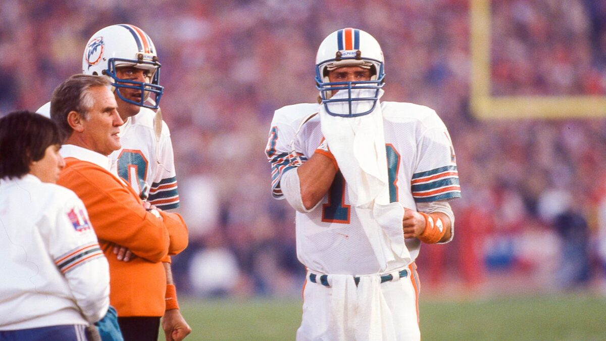dan marino of the miami dolphins discussing with coach