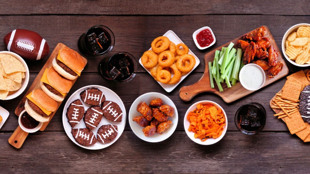 an assembly of food typically found at parties, wings, sliders, chips exc.