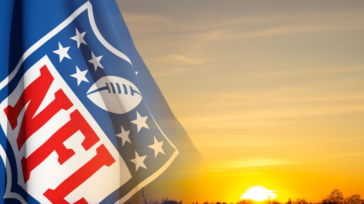 10 Iconic Football Stadiums Every Fan Should Experience 12 nfl flag with sunset backdrop
