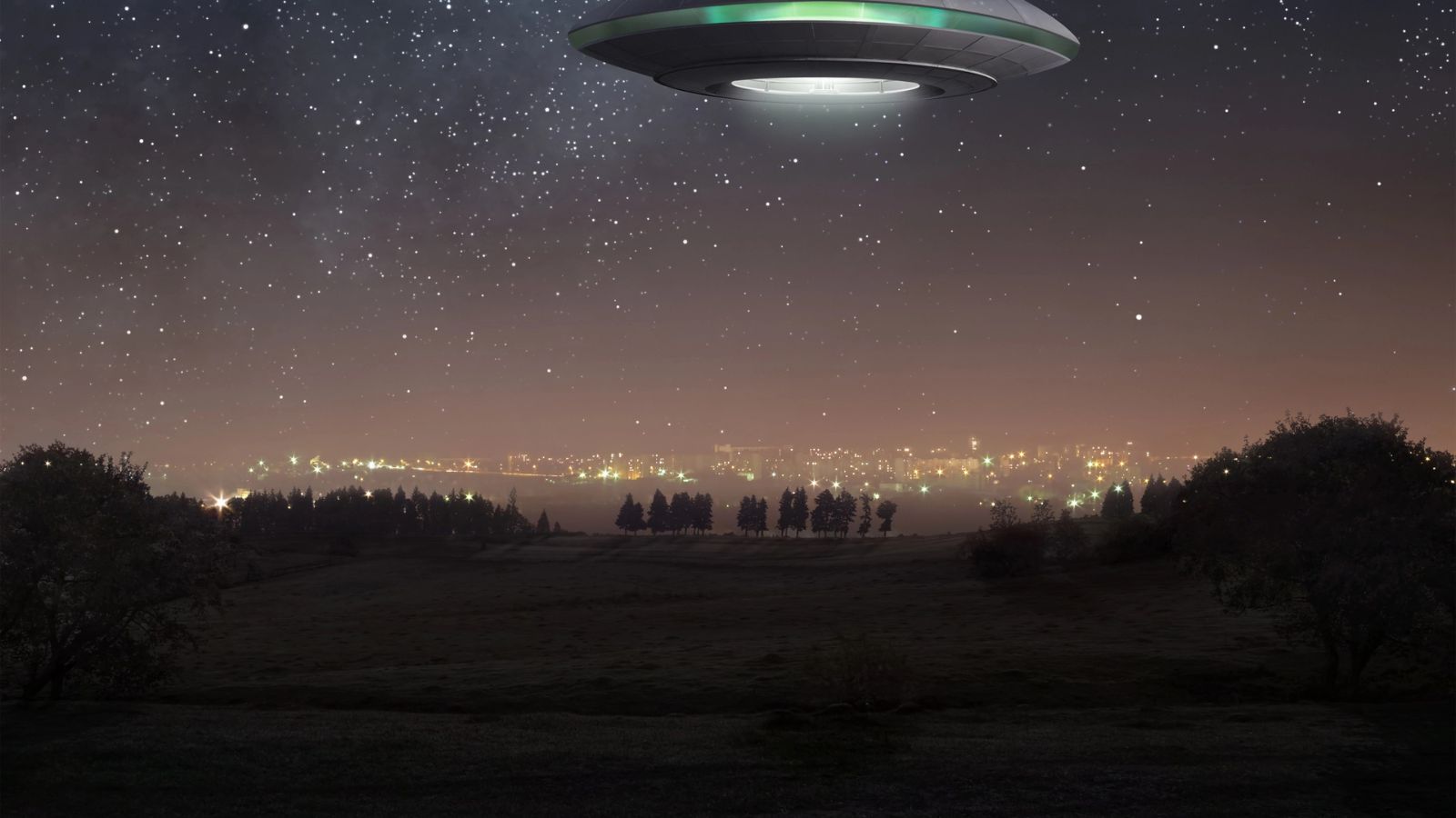 ufo overlooking a major city in the woods