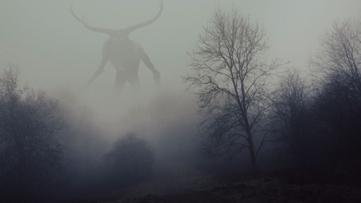 wendigo shadow in the mist above the trees