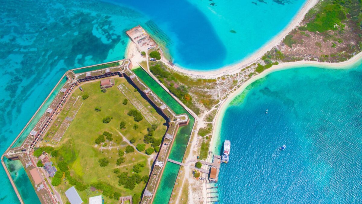The Cheapest Way To Get To Dry Tortugas National Park 8 Aerial view of a coastal fortress on a clear day with turquoise waters surrounding it.