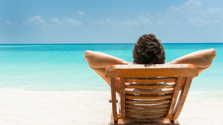 Person relaxing on a beach chair by the sea
