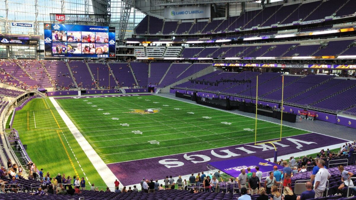 10 Iconic Football Stadiums Every Fan Should Experience 11 The interior of U.S. Bank Stadium, home to the Minnesota Vikings, showcasing its modern design with angular shapes and a closed roof. The purple seating and the clear view of the indoor field highlight the stadium's contemporary aesthetic.