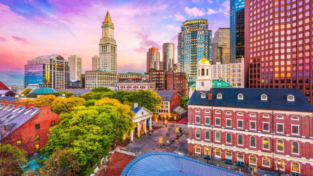 A vibrant cityscape at sunset with a mix of historic and modern architecture, featuring the iconic clock tower and a bustling marketplace.