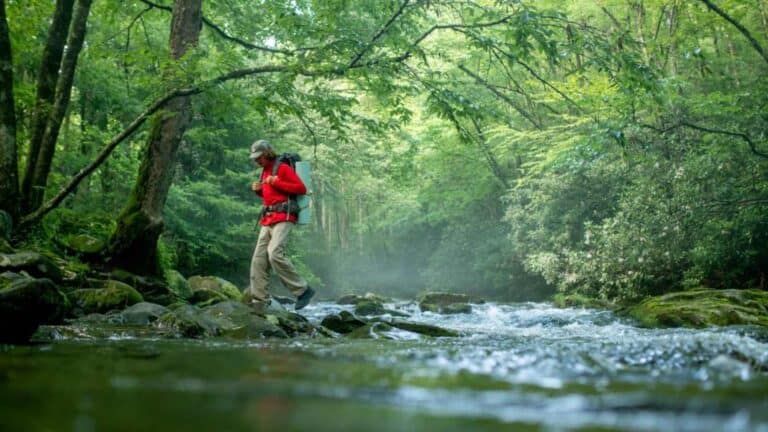 a man walking across a river