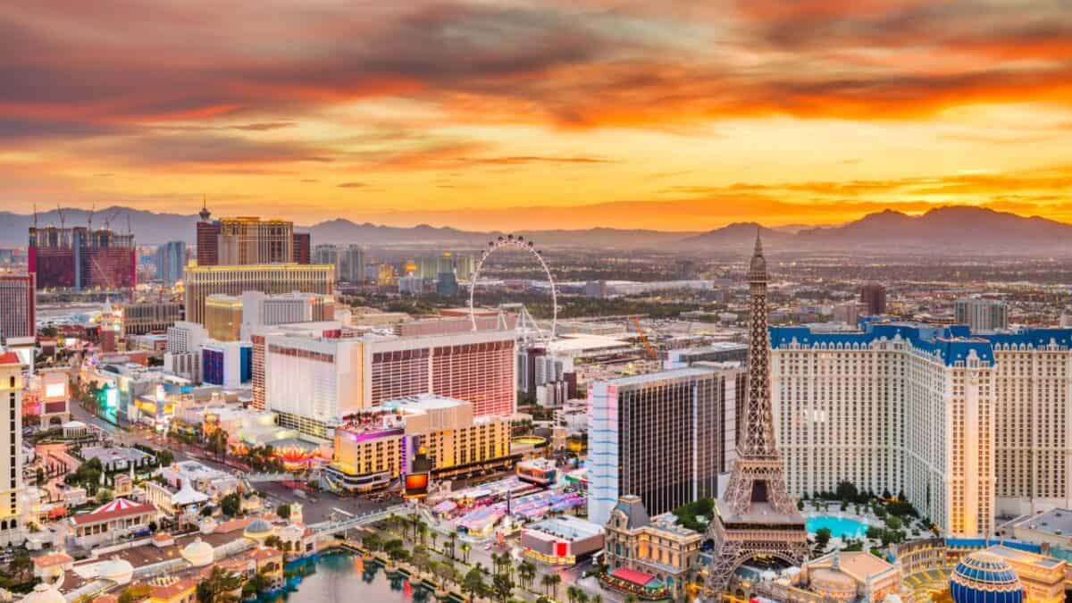 A vibrant sunset over the bustling las vegas strip, showcasing the city's iconic casinos and attractions under a dramatic sky.