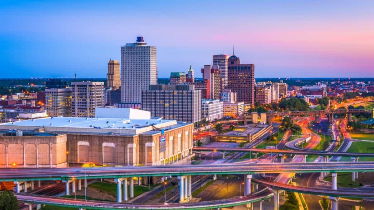 Twilight hues blanket a bustling cityscape, where the glow of urban life intertwines with the serene sky, and intricate highways weave through the beating heart of the metropolis.