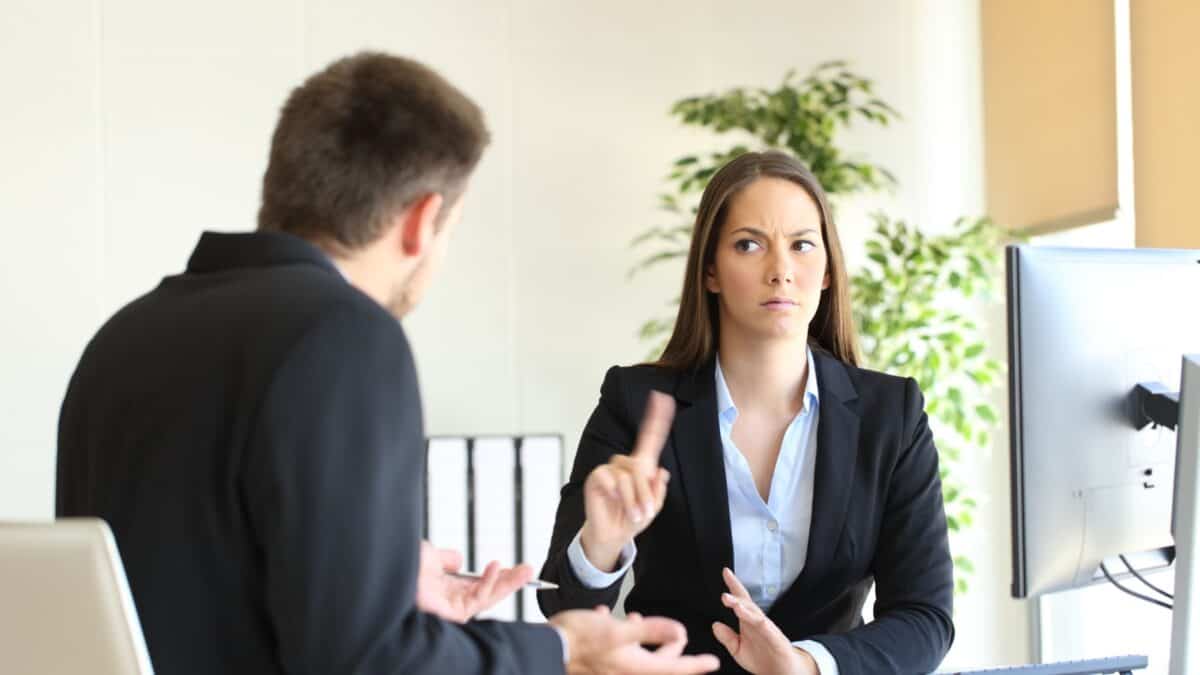 A woman in a business attire saying no to her colleague.