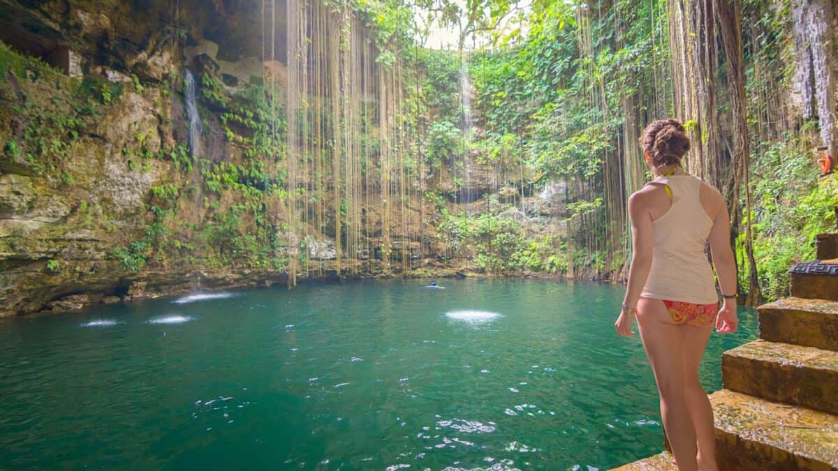 A woman standing by Ik kil Cenote.