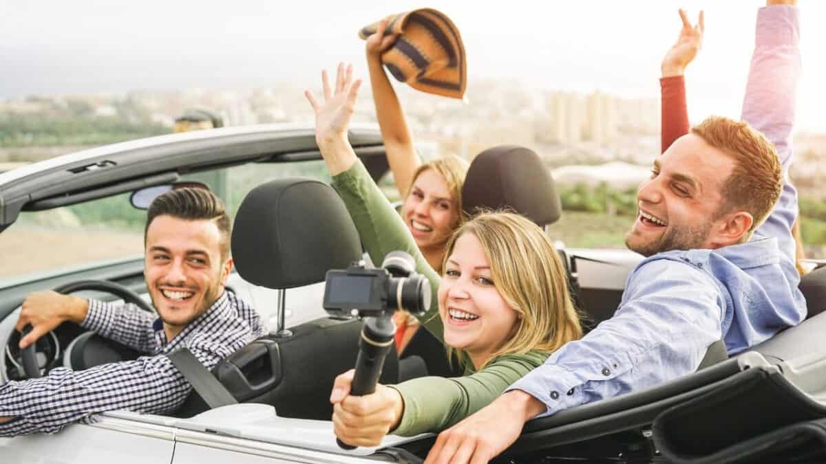 a group of people in a convertible car