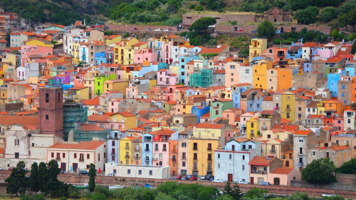 15 Nostalgic Travel Destinations for Anyone Who Grew Up in the '70s 11 Colorful houses densely packed on a hillside, with green trees and vegetation in the foreground.