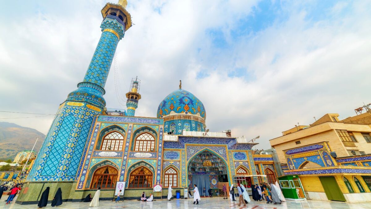 15 Nostalgic Travel Destinations for Anyone Who Grew Up in the '70s 3 Blue-tiled mosque with people walking in the courtyard under a cloudy sky.